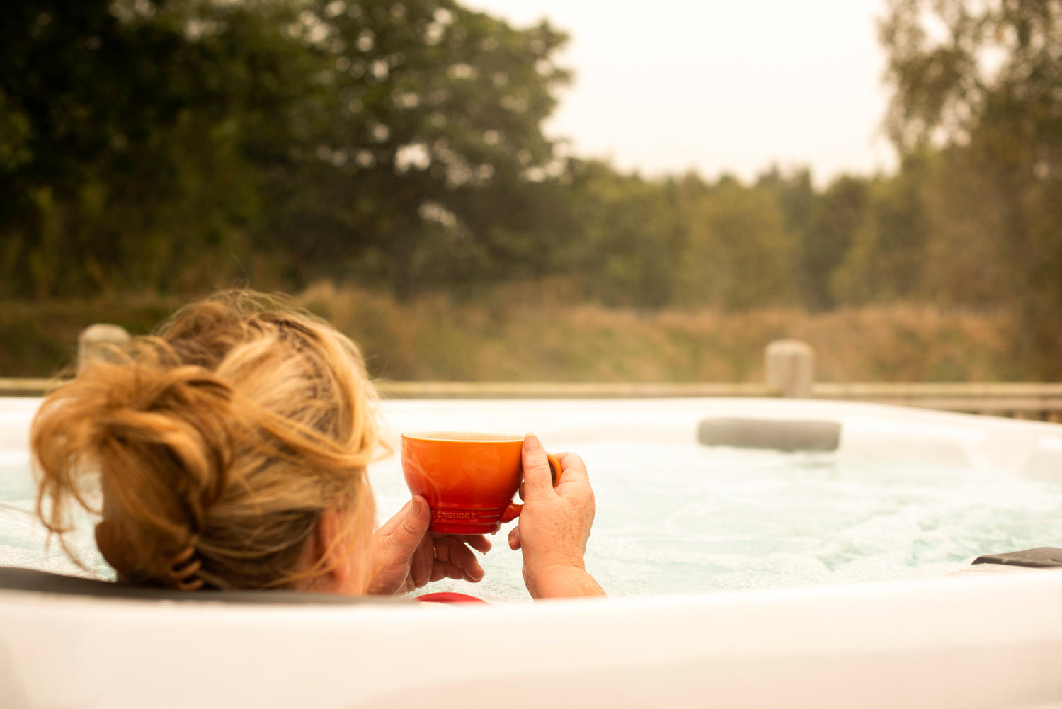 Enjoying a cup of coffee in one of our private hot tubs.