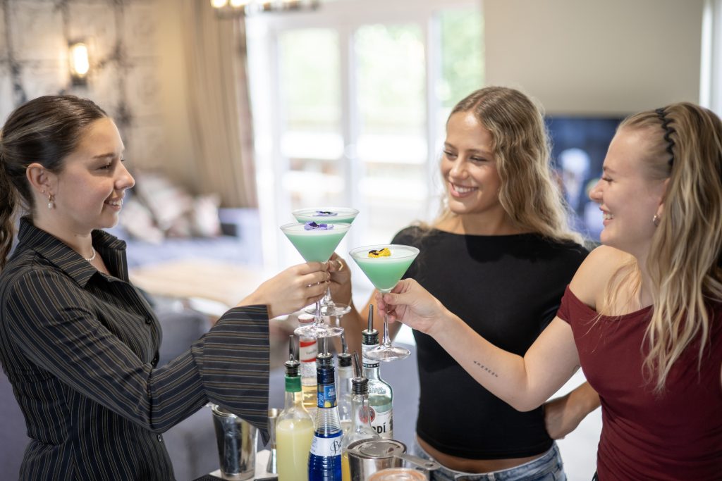 Friends & family on their group stay toasting glasses in their cocktail masterclass session